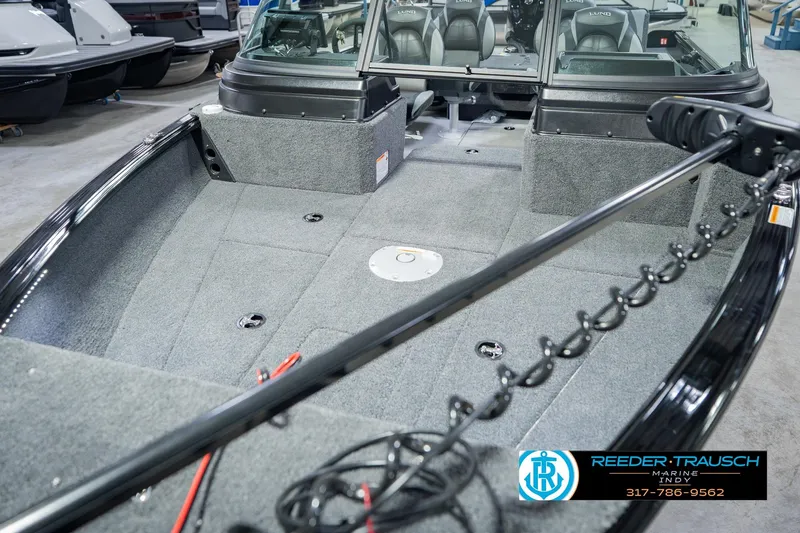 Slide: The Image of 2026 Lund 1775 Impact XS boat interior with carpeted deck and seating. - 11