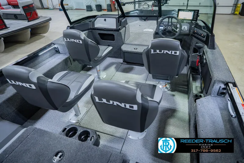 Slide: The Image of 2026 Lund 1775 Impact XS boat interior with four seats and steering console. - 13