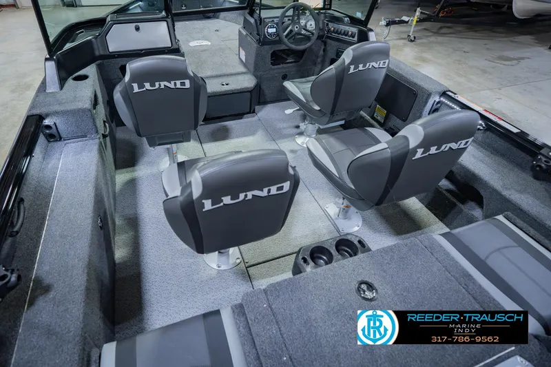 Slide: The Image of 2026 Lund 1775 Impact XS boat interior with four seats and steering console. - 14
