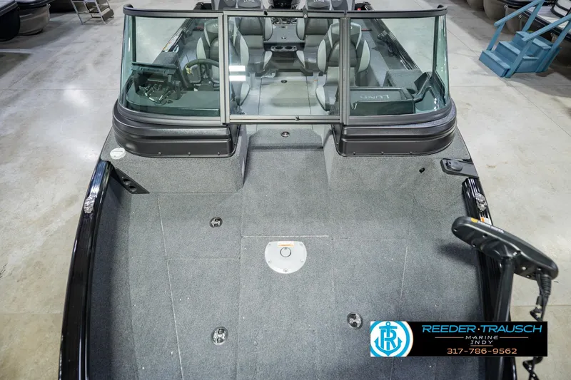 Slide: The Image of 2026 Lund 1775 Impact XS boat interior with seating and steering wheel, showcased at Reeder Trausch Marine. - 17