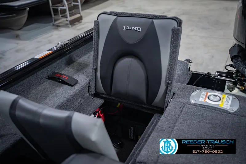 Slide: The Image of 2026 Lund 1775 Impact XS boat interior with gray seating and storage compartments. - 22