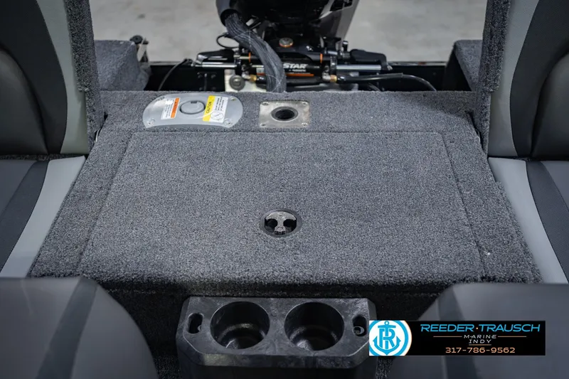Slide: The Image of 2026 Lund 1775 Impact XS boat interior with carpeted flooring and cup holders. - 23