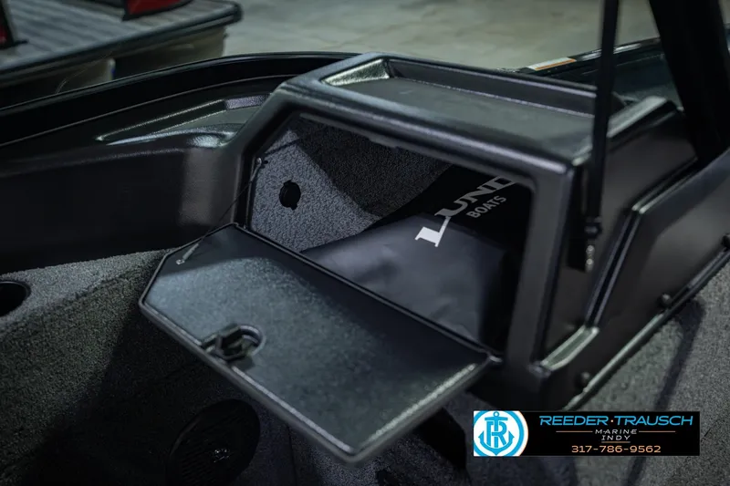 Slide: The Image of 2026 Lund 1775 Impact XS boat storage compartment with open lid, showcasing interior space. - 28