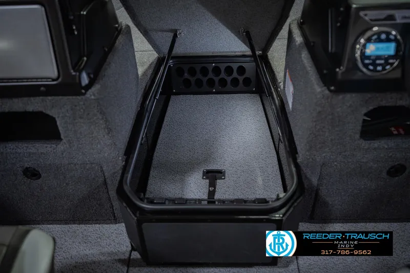 Slide: The Image of Interior storage compartment of 2026 Lund 1775 Impact XS boat, featuring carpeted finish. - 30