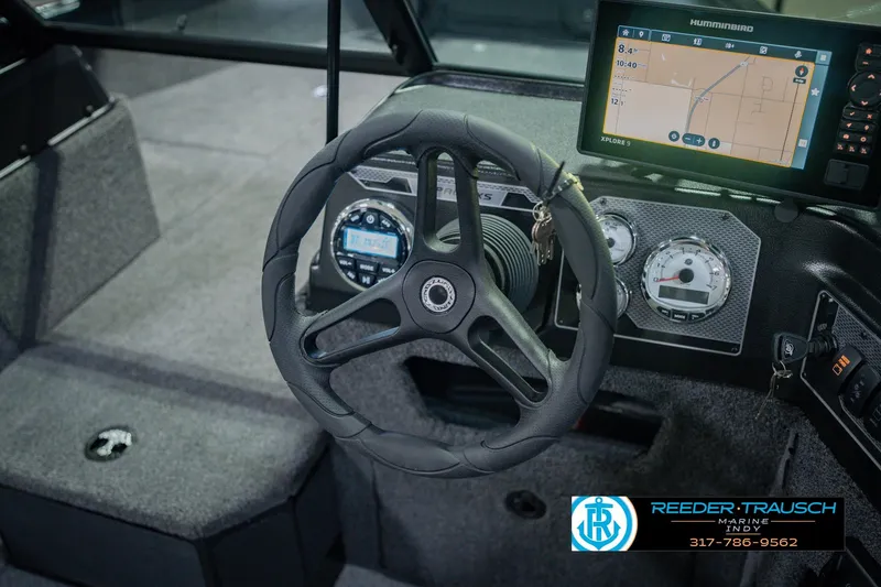 Slide: The Image of 2026 Lund 1775 Impact XS boat dashboard with steering wheel and navigation display. - 31