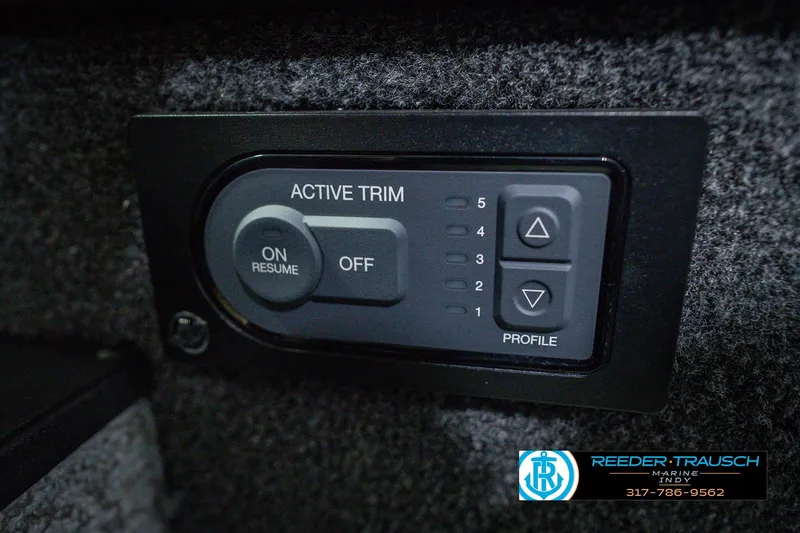 Slide: The Image of Active trim control panel on 2026 Lund 1775 Impact XS boat dashboard. - 39