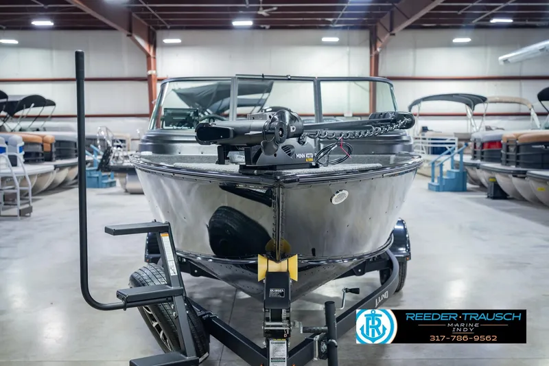 Slide: The Image of 2026 Lund 1775 Impact XS boat on trailer in showroom setting. - 4