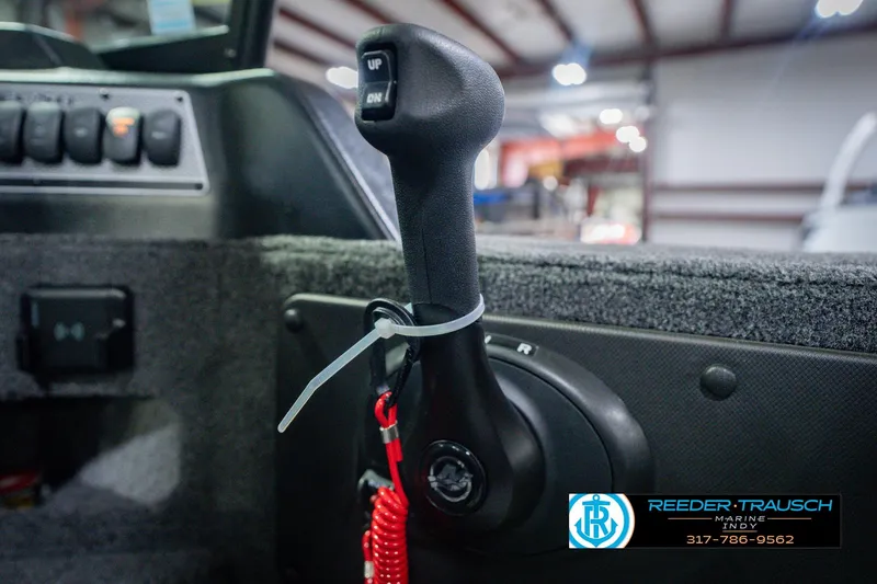 Slide: The Image of Close-up of 2026 Lund 1775 Impact XS boat throttle control in a showroom. - 40