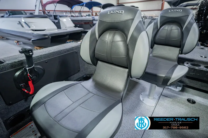 Slide: The Image of 2026 Lund 1775 Impact XS boat seats in showroom, featuring sleek design and comfort. - 41