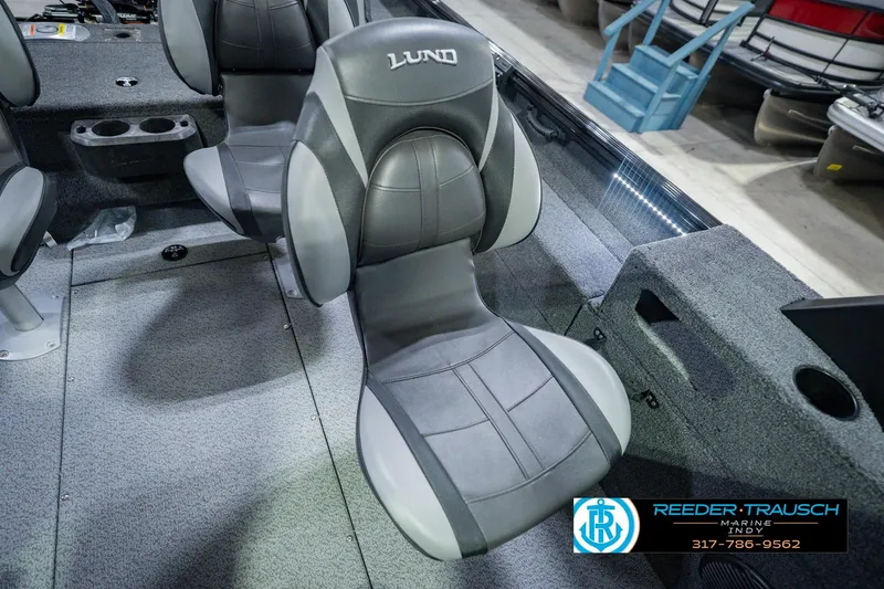 Slide: The Image of 2026 Lund 1775 Impact XS boat interior with gray seating and carpeted flooring. - 44
