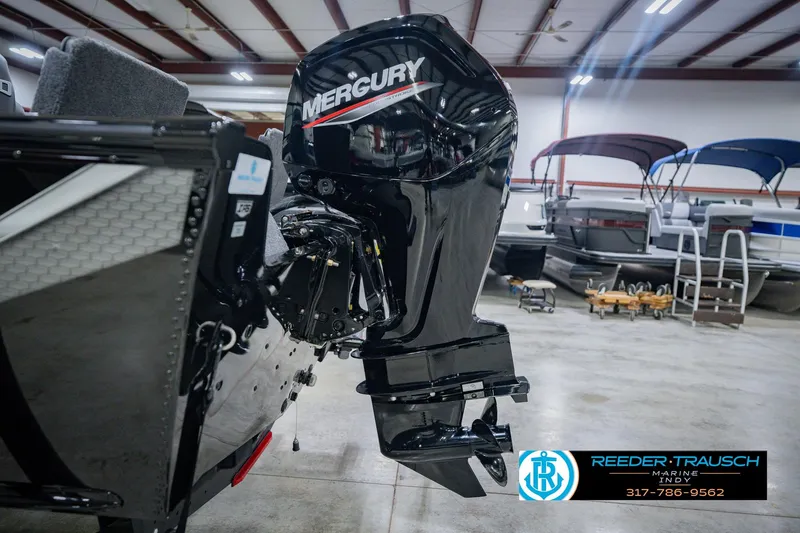 Slide: The Image of 2026 Lund 1775 Impact XS boat with Mercury outboard motor in showroom. - 50