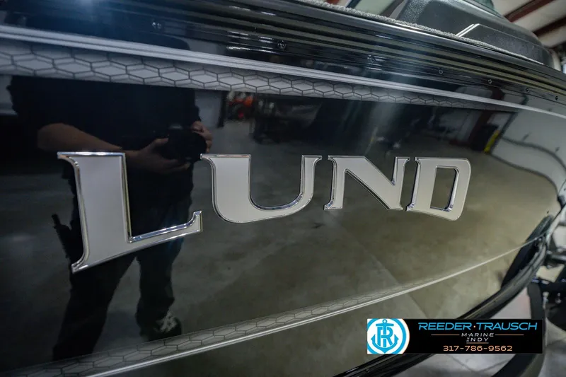 Slide: The Image of 2026 Lund 1775 Impact XS boat with sleek black exterior and prominent logo. - 59