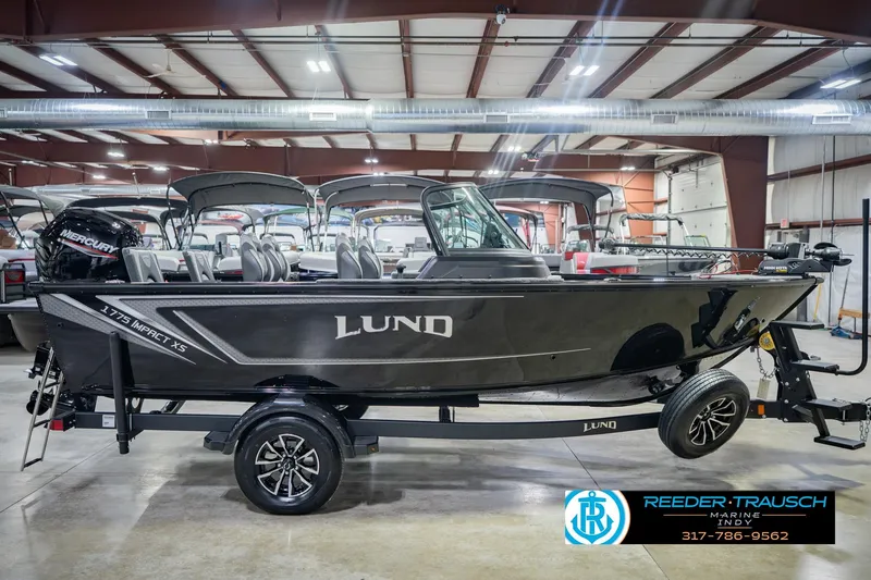 Slide: The Image of 2026 Lund 1775 Impact XS boat in showroom, side view, on trailer. - 6