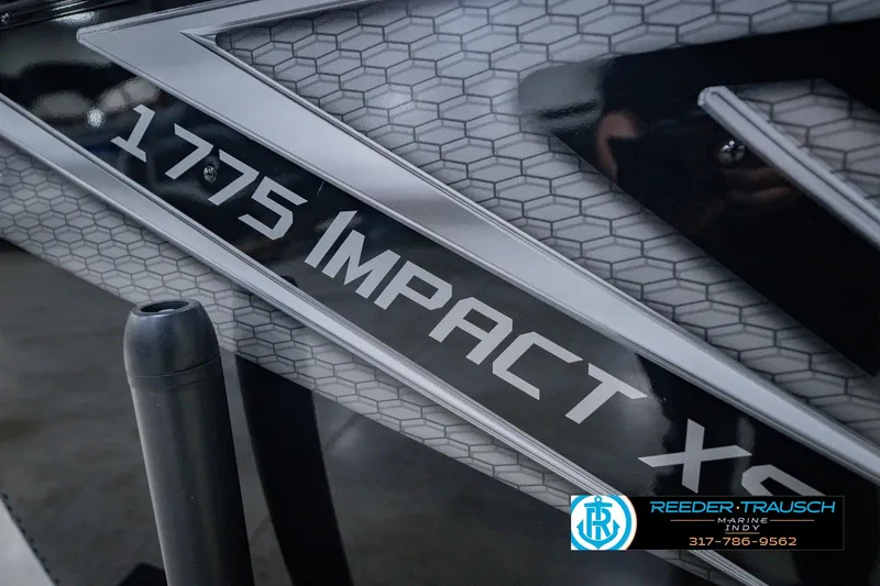 Slide: The Image of 2026 Lund 1775 Impact XS boat with hexagonal pattern and Reeder-Trausch Marine logo. - 60
