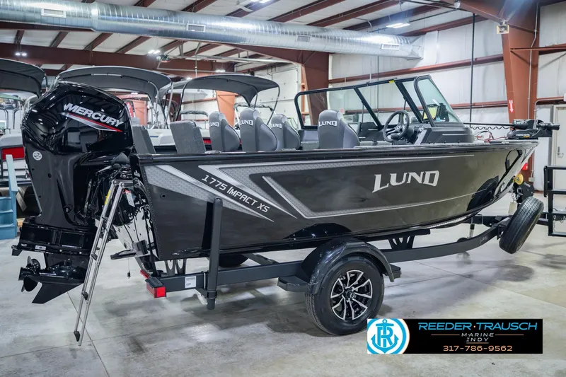 Slide: The Image of 2026 Lund 1775 Impact XS boat with Mercury engine in showroom setting. - 7