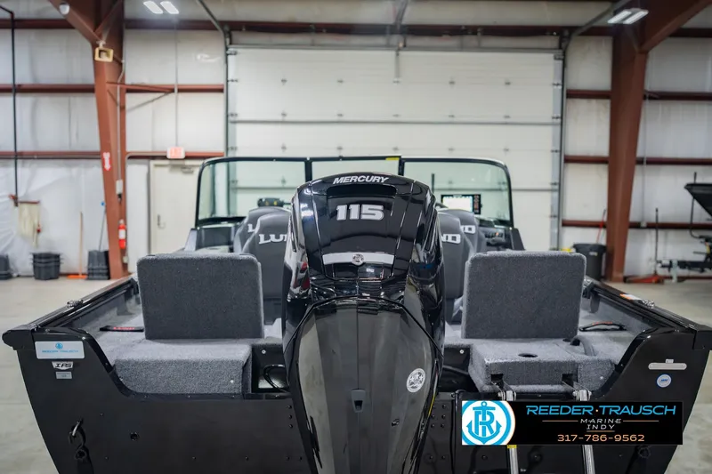 Slide: The Image of 2026 Lund 1775 Impact XS boat with Mercury 115 engine in a garage setting. - 8