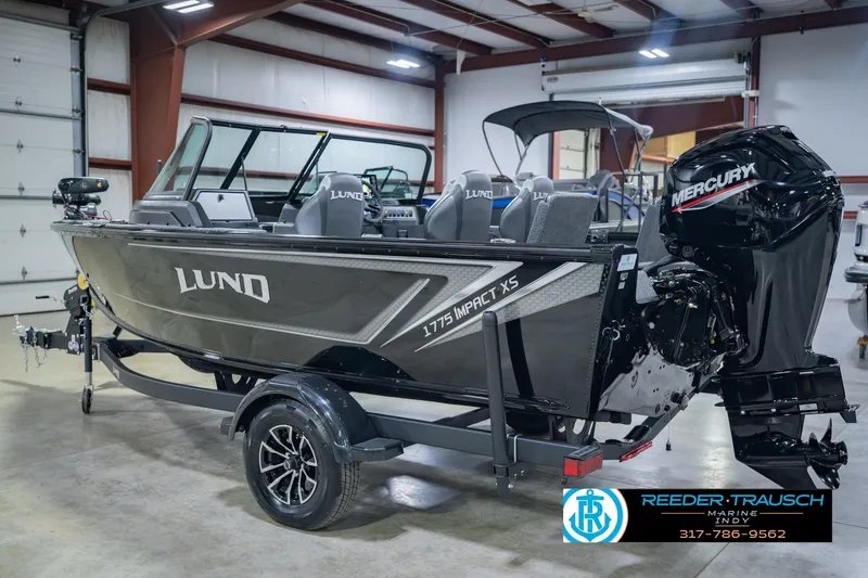 Slide: The Image of 2026 Lund 1775 Impact XS boat in showroom with Mercury engine. - 9