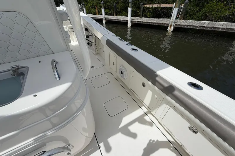 Slide: The Image of 2020 World Cat 295 CC boat interior with sleek design and dockside view. - 11