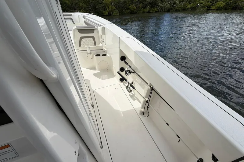 Slide: The Image of 2020 World Cat 295 CC boat interior with fishing rods by the water. - 16