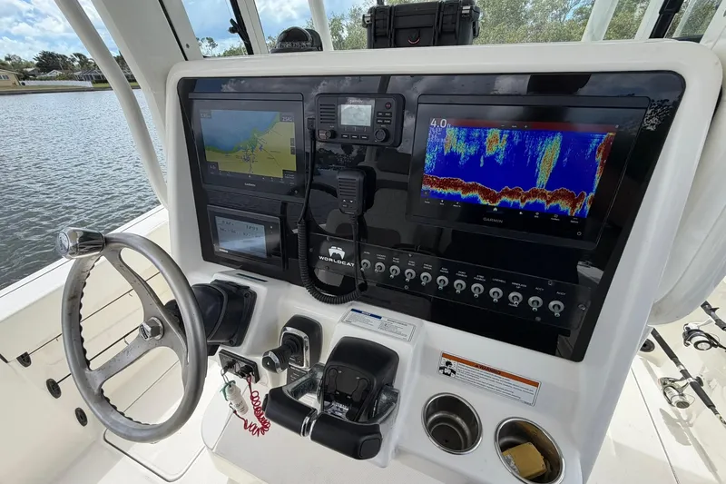 Slide: The Image of 2020 World Cat 295 CC boat dashboard with navigation and sonar displays. - 17