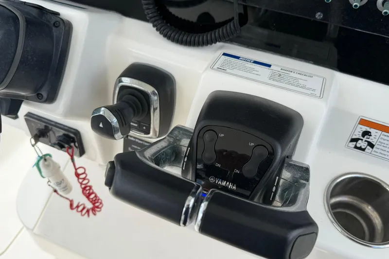 Slide: The Image of Control panel of a 2020 World Cat 295 CC boat featuring Yamaha throttle controls. - 18