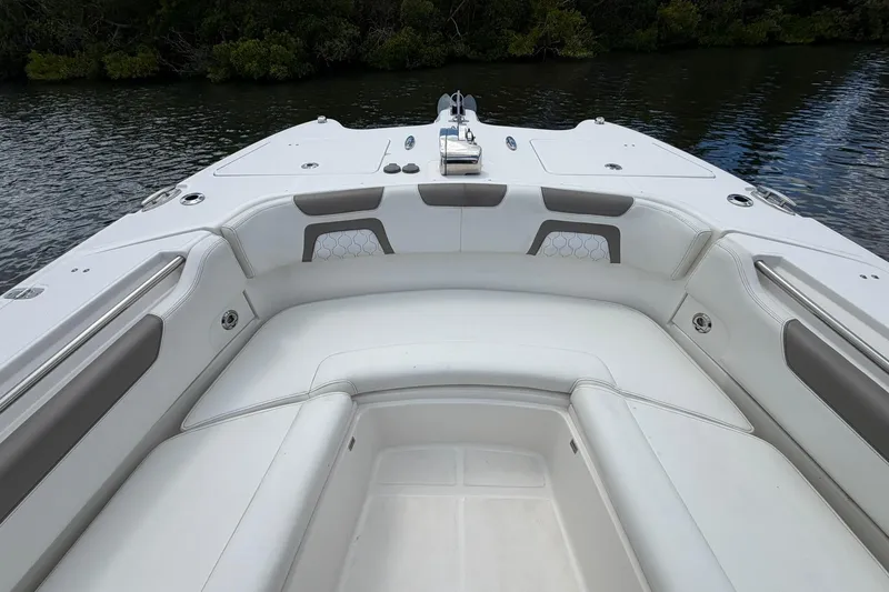 Slide: The Image of 2020 World Cat 295 CC boat interior with white seating and water view. - 24