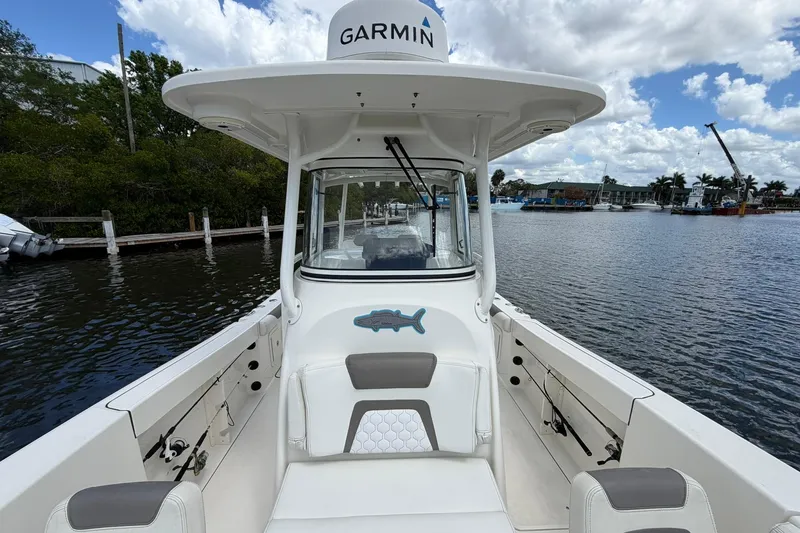 Slide: The Image of 2020 World Cat 295 CC boat with Garmin equipment on a calm waterway. - 26