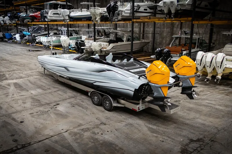 Slide: The Image of 2026 Doug Wright 36 powerboat with dual yellow engines in a storage facility. - 3