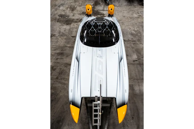 Slide: The Image of Top view of a sleek 2026 Doug Wright 36 powerboat with yellow accents. - 7
