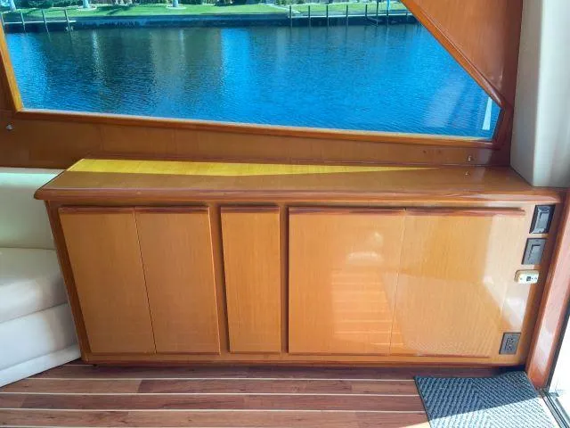 Slide: The Image of Interior of 1999 Viking 50 Convertible yacht with wooden cabinetry and water view. - 16