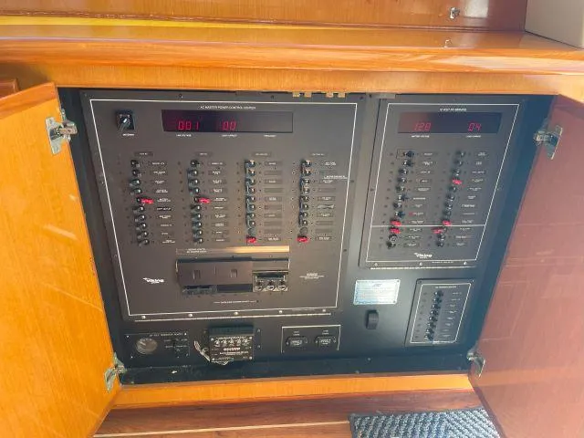 Slide: The Image of Electrical panel inside a 1999 Viking 50 Convertible yacht, showcasing circuit breakers and controls. - 17