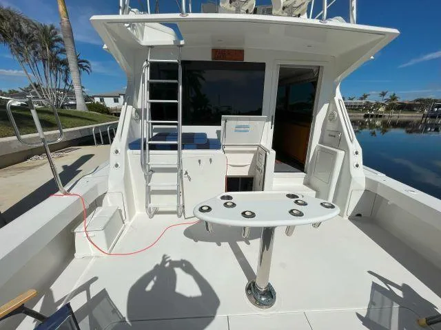 Slide: The Image of 1999 Viking 50 Convertible yacht deck with fishing rod holders and ladder. - 2