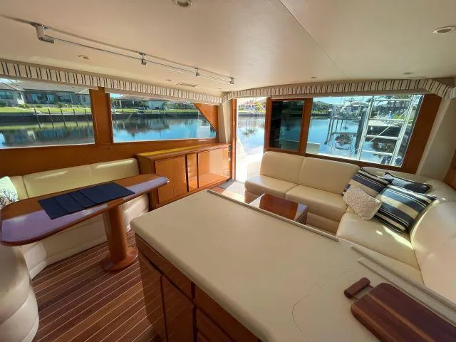 Slide: The Image of Interior of 1999 Viking 50 Convertible yacht with elegant seating and waterfront view. - 20