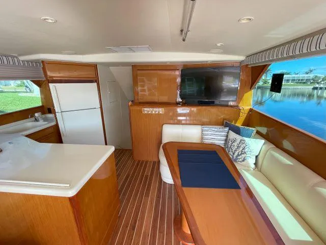 Slide: The Image of Interior of 1999 Viking 50 Convertible yacht with kitchen, dining area, and large window view. - 21