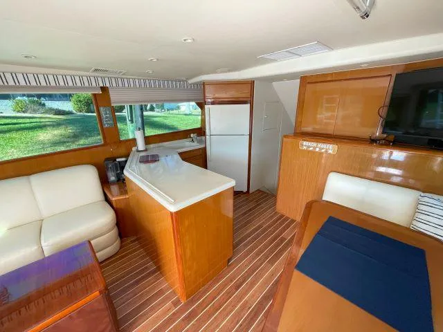 Slide: The Image of Interior of 1999 Viking 50 Convertible yacht with modern kitchen and seating area. - 22