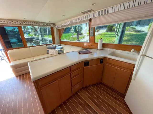 Slide: The Image of Interior of 1999 Viking 50 Convertible yacht with modern kitchen and seating area. - 26