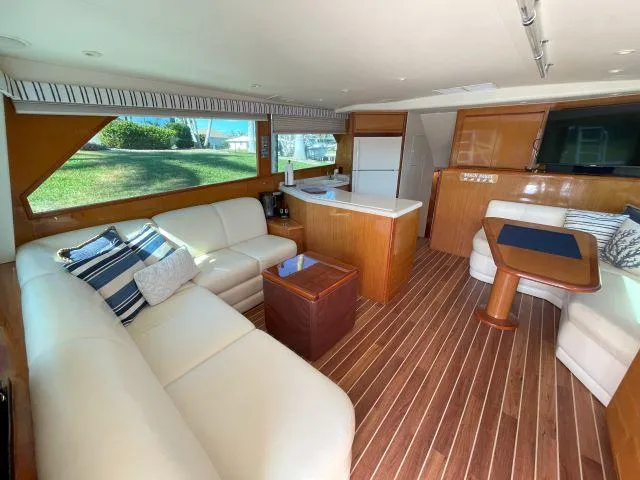 Slide: The Image of Luxurious interior of a 1999 Viking 50 Convertible yacht with elegant seating and wood flooring. - 31