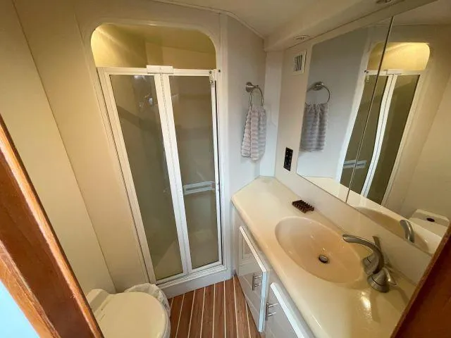 Slide: The Image of Bathroom interior of 1999 Viking 50 Convertible yacht with shower and sink. - 39
