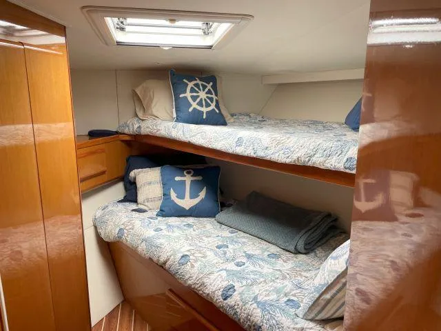 Slide: The Image of Cozy cabin with bunk beds in a 1999 Viking 50 Convertible yacht. - 42