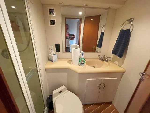 Slide: The Image of Bathroom interior of a 1999 Viking 50 Convertible yacht with shower and vanity. - 44