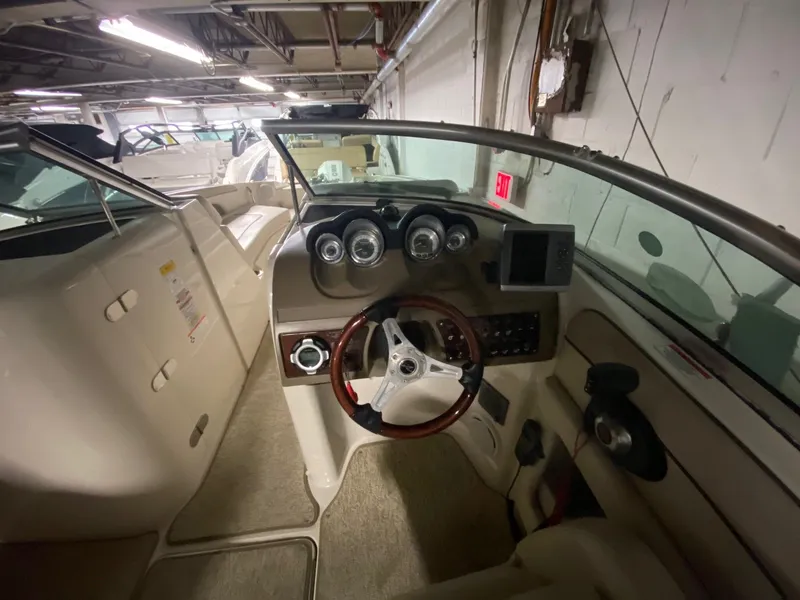 Slide: The Image of Interior of a 2010 Sea Ray 280 Sundeck boat with steering console. - 4