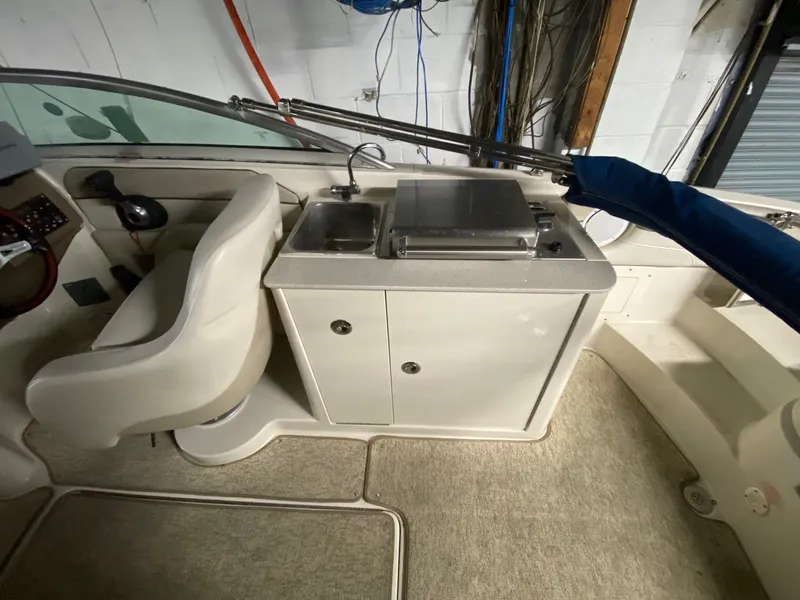 Slide: The Image of Interior of a 2010 Sea Ray 280 Sundeck with seat and sink. - 7