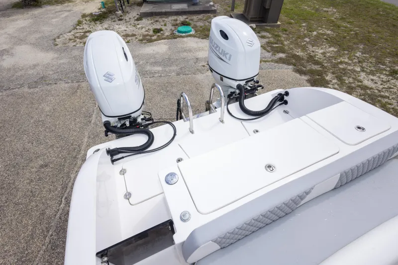 Slide: The Image of 2022 Twin Vee 240 GFX CC boat with dual Suzuki outboard motors. - 14