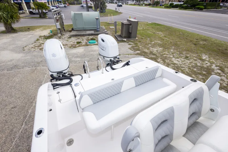 Slide: The Image of 2022 Twin Vee 240 GFX CC boat with dual Suzuki outboard motors and cushioned seating. - 16