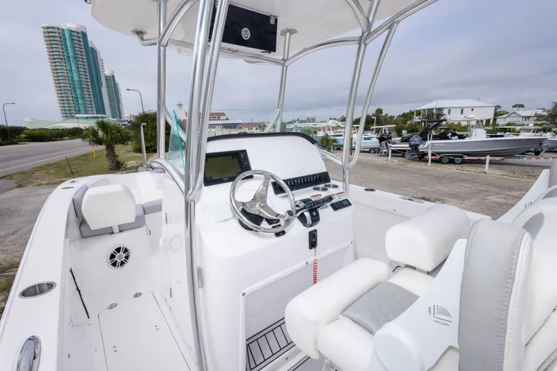 Slide: The Image of 2022 Twin Vee 240 GFX CC boat interior with modern console and seating. - 18