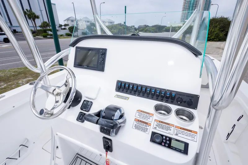 Slide: The Image of 2022 Twin Vee 240 GFX CC boat console with steering wheel and electronic controls. - 20