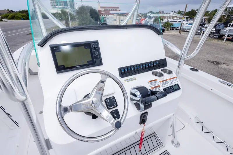 Slide: The Image of 2022 Twin Vee 240 GFX CC boat console with steering wheel and navigation system. - 21