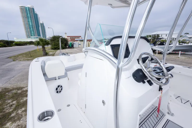 Slide: The Image of 2022 Twin Vee 240 GFX CC boat interior with steering wheel and seating. - 22