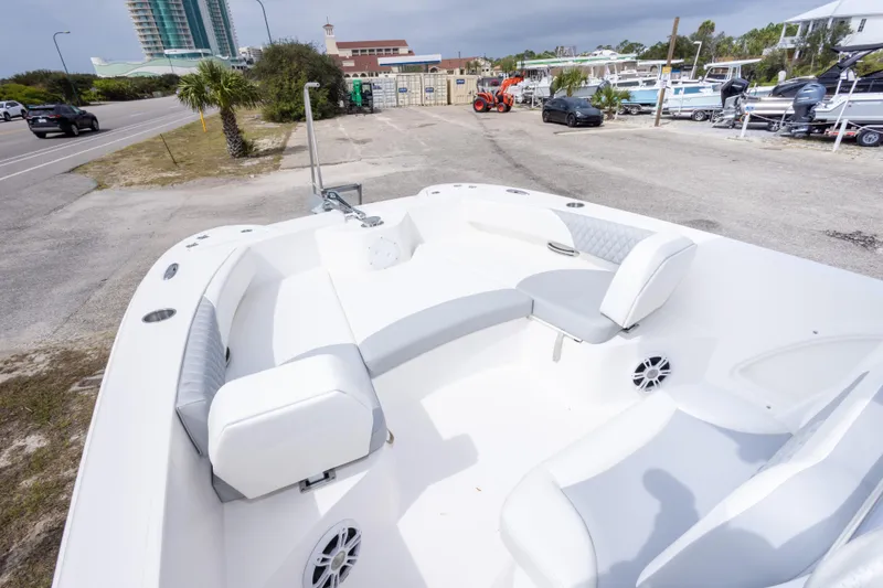 Slide: The Image of 2022 Twin Vee 240 GFX CC boat with spacious seating, parked near a road. - 26