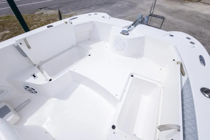 Slide: The Image of 2022 Twin Vee 240 GFX CC boat interior with spacious seating and storage compartments. - 28